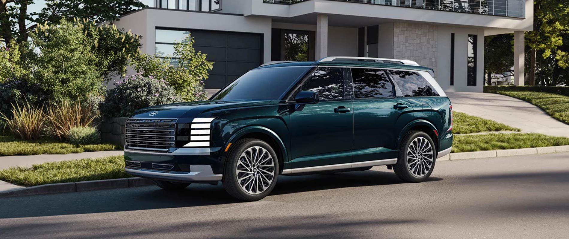 A green Hyundai Palisade parked on the street outside a nice house.